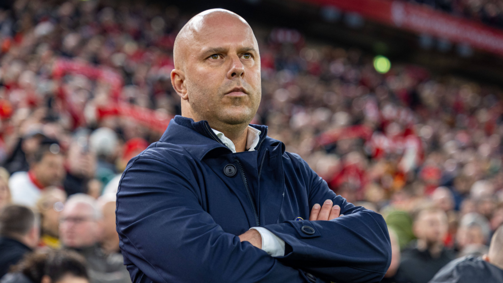 Liverpool manager Arne Slot stood with his arms crossed on the touchline at Anfield.