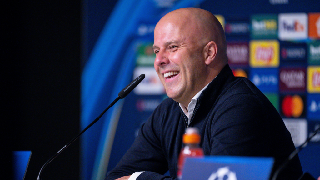 Liverpool manager Arne Slot laughs during a Champions League press conference.