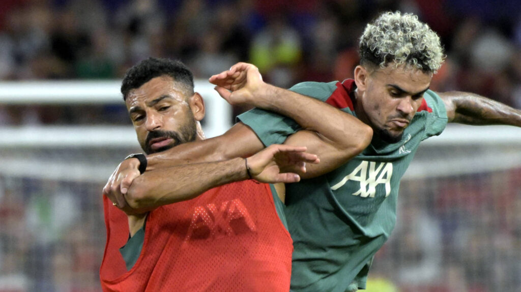 Liverpool stars Luiz Diaz and Mohamed Salah battling.