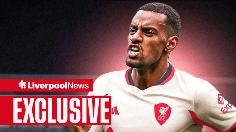 Alexander Isak celebrates wearing a Liverpool shirt.