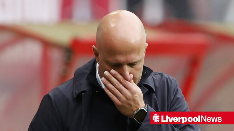 Liverpool manager Arne Slot places his hand over his face in frustration.
